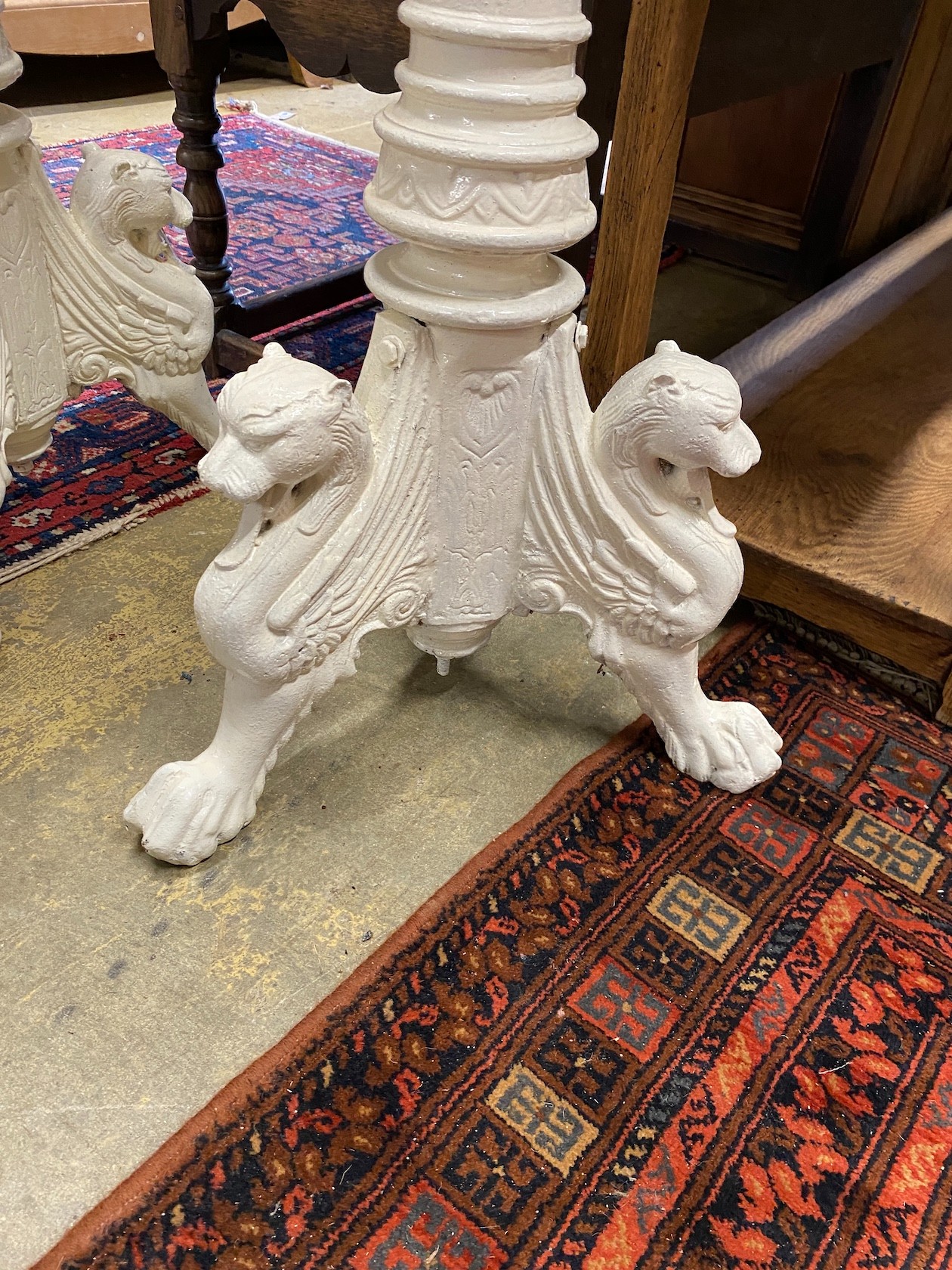 A pair of Victorian style painted cast iron pricket candlestands, height 122cm